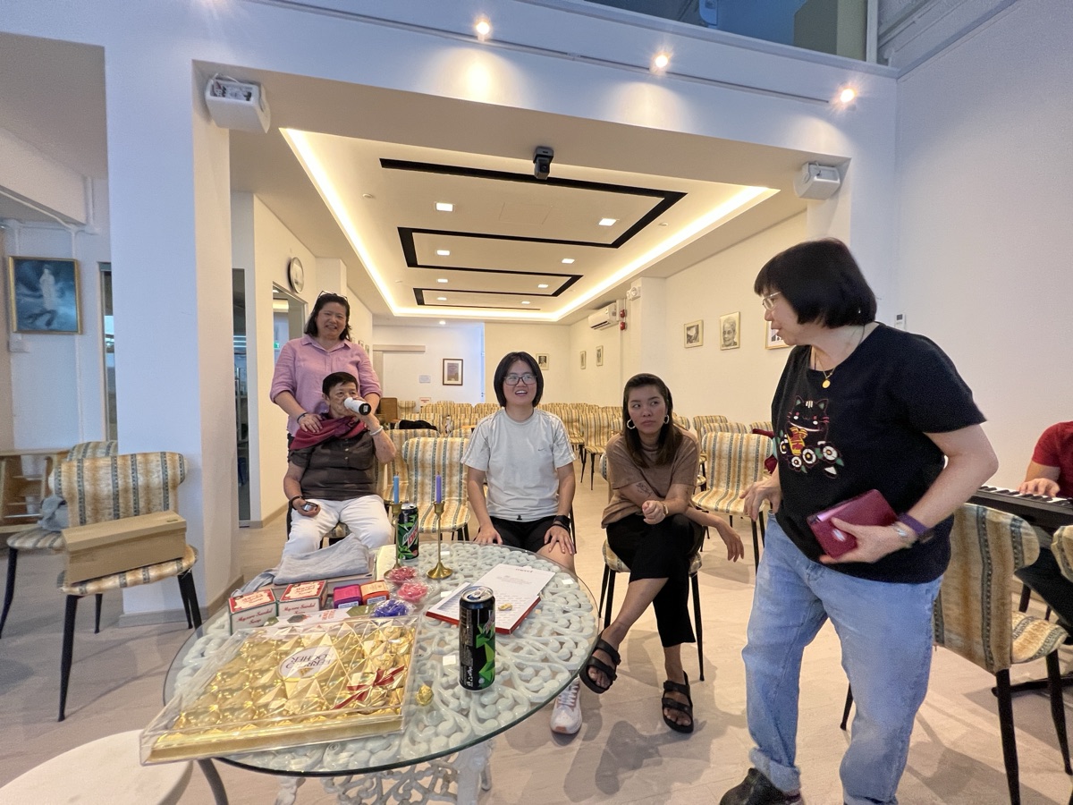 People gathering around a table in a community room