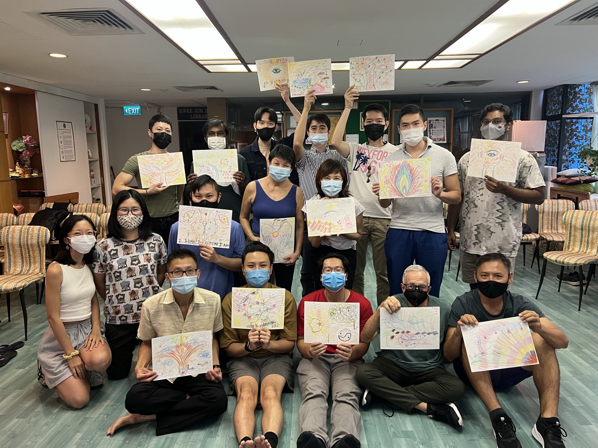 Lotus Circle workshop participants posing together with their artwork