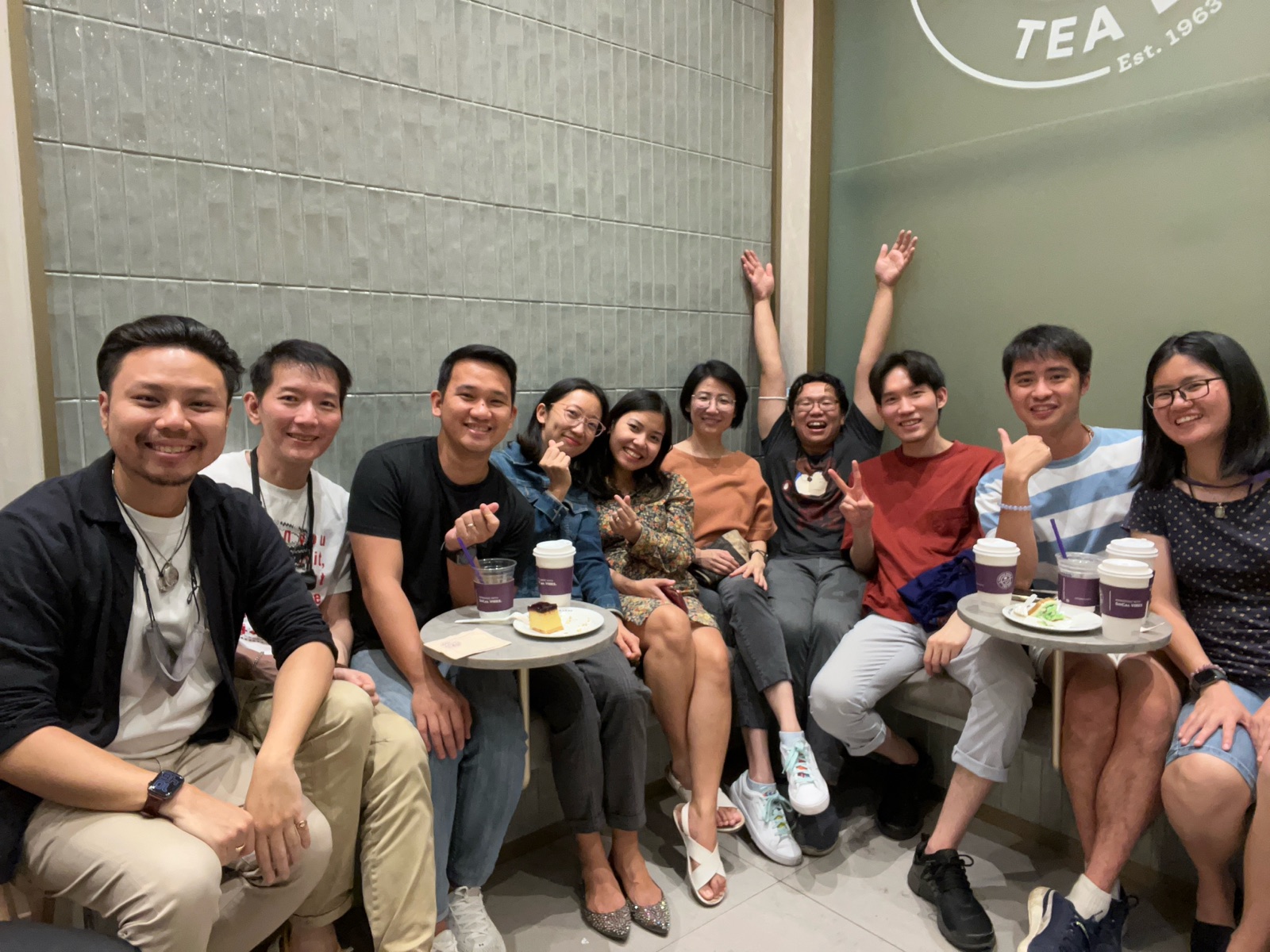 A group of people smiling together at a cafe